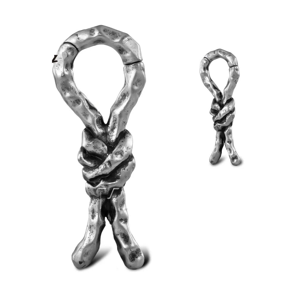 Close-up of copper earrings with a 4mm gauge featuring intricate bends and hitches design