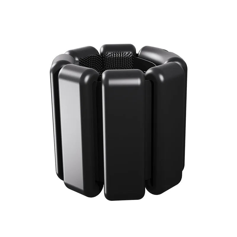 Detachable silicone-padded wrist weight bracelet with Velcro strap in black, showing 1lb and 2lb options.