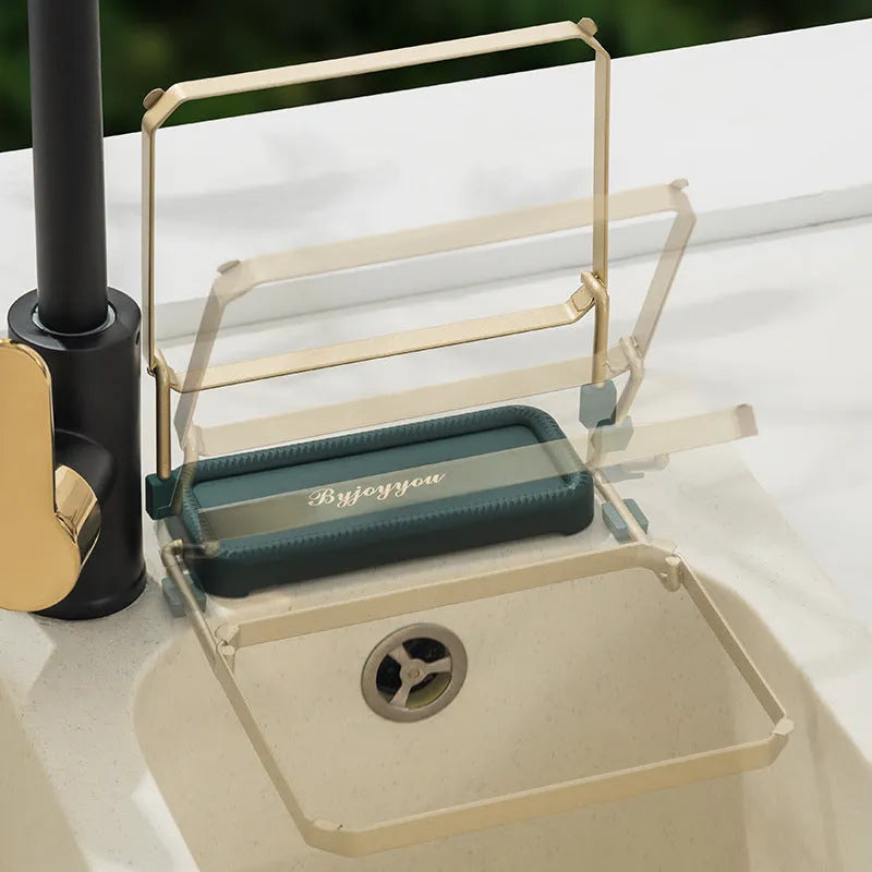 Foldable sink filter rack in dark green gold with disposable mesh bag on a stainless steel sink