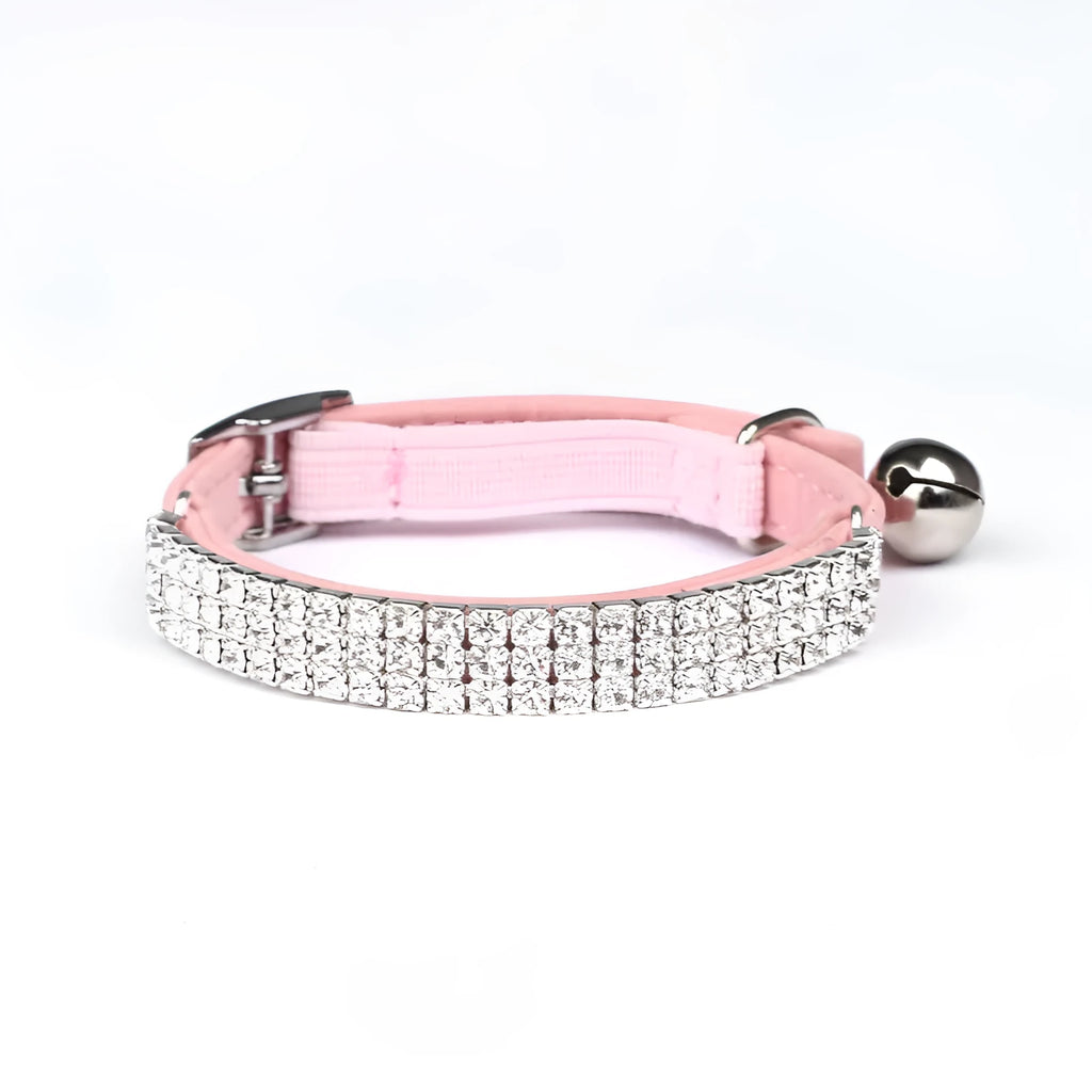 A red suede velvet cat collar with rhinestone decoration, showing the adjustable buckle.