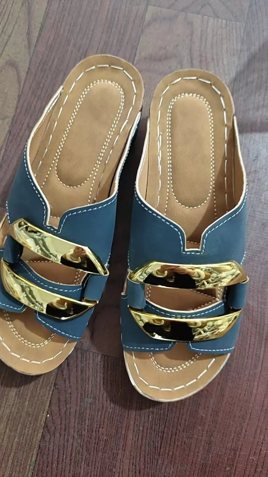 Pair of Roman-style platform flip-flop sandals on a solid colour background.