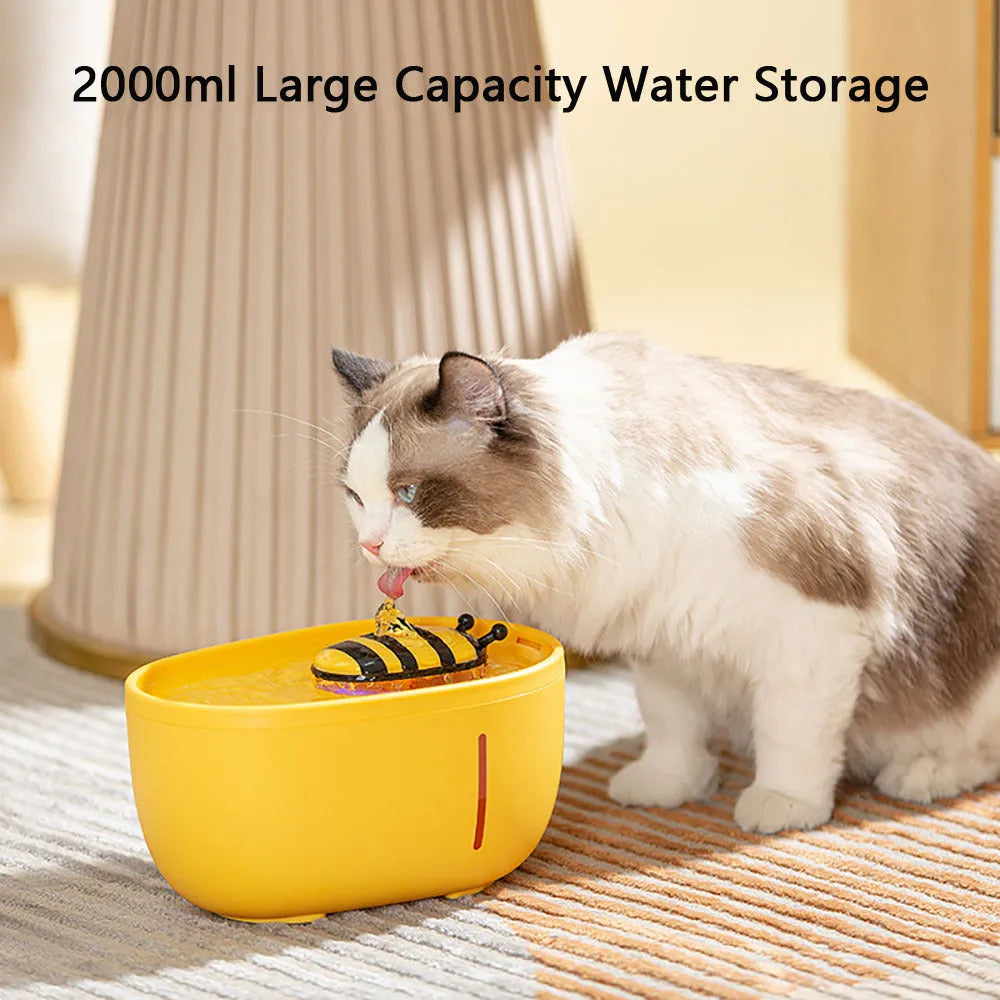 Yellow automatic cat water fountain with filter and silent USB pump on anti-slip base.