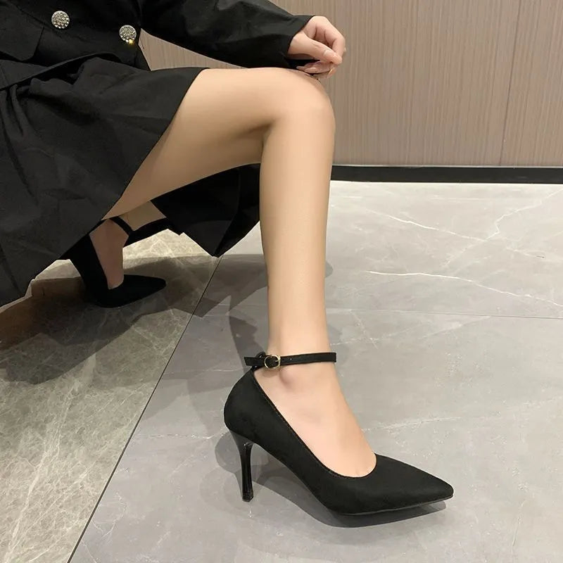 Women's black stiletto heels with skull pattern and buckle detailing on stiletto heel
