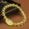 Yellow leather bracelet with artificial crystal Pi Xiu bead in simple Chinese style.