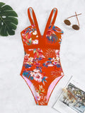 Women's black floral backless one-piece swimsuit on a model, showing spandex lining and high elasticity fit.