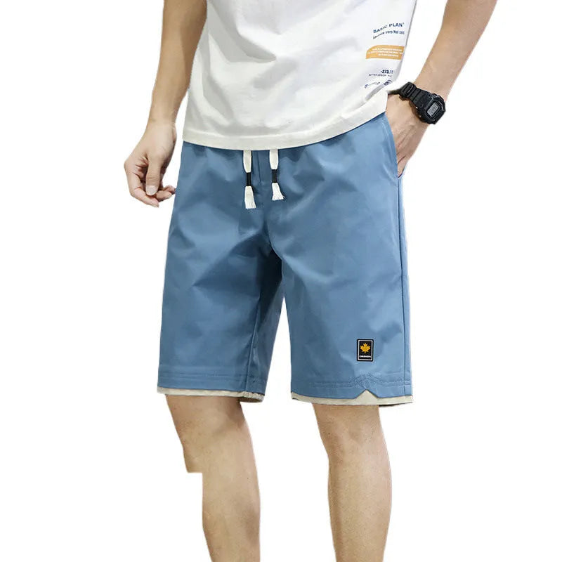 Korean style loose-fit straight-leg casual shorts in green, shown on a model.