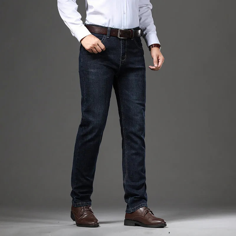 Man wearing loose fit straight-leg stretch jeans in blue denim for a business casual look.
