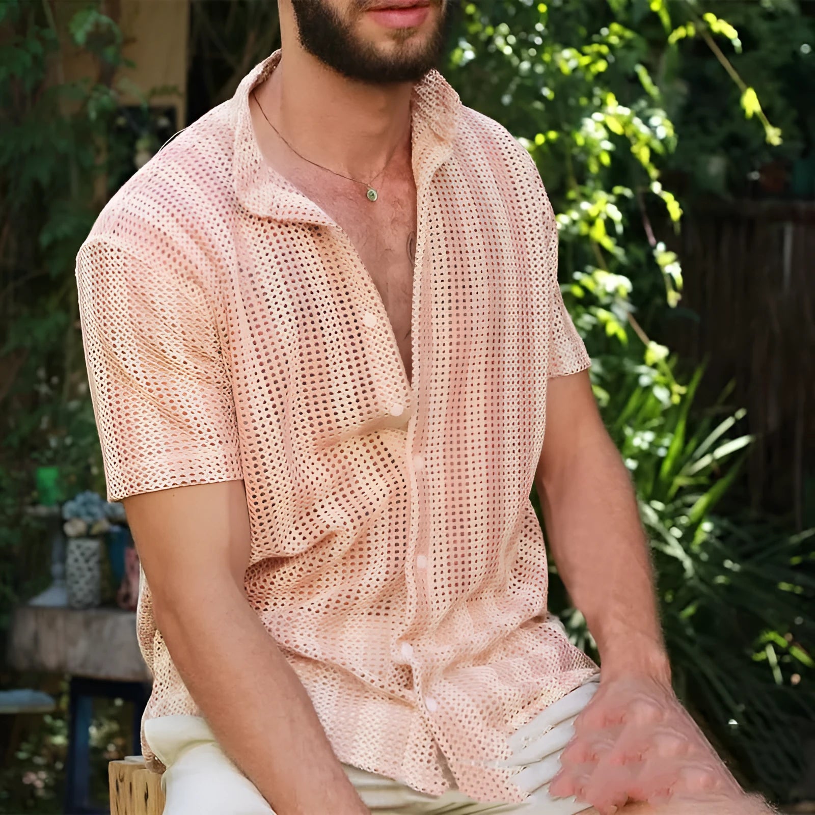 Pink men's loose-fit cardigan shirt with short sleeves and a waffle-textured fabric.