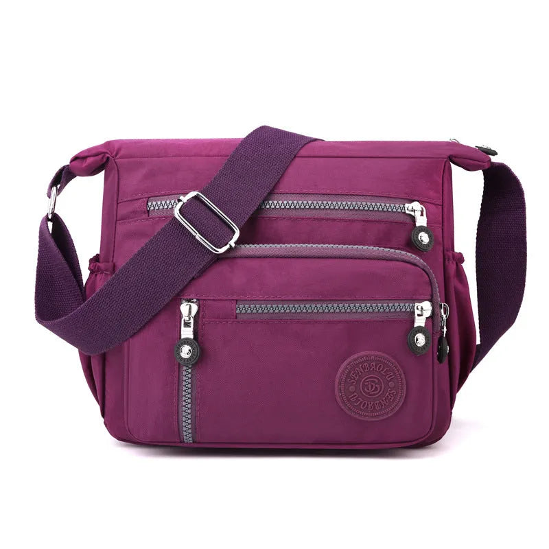 Lightweight nylon shoulder messenger bag in square vertical shape with single strap.