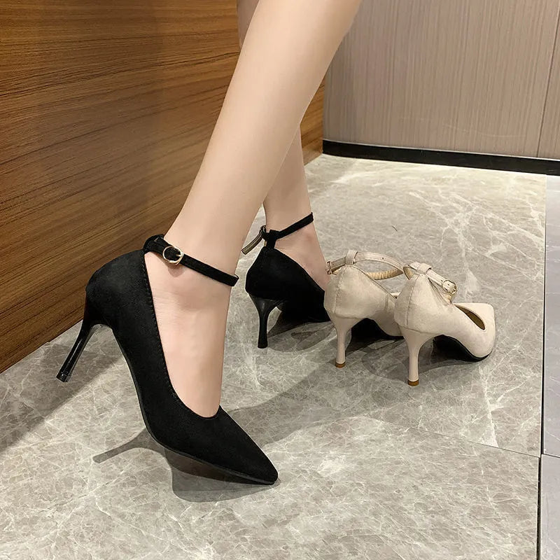 Women's black stiletto heels with skull pattern and buckle detailing on stiletto heel