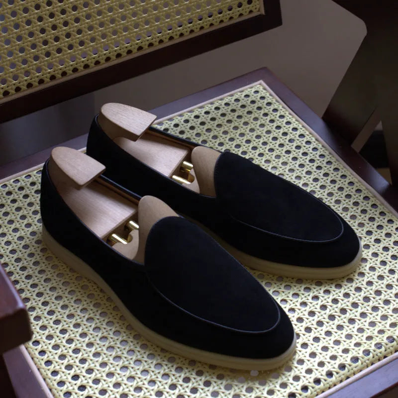 Men's black genuine leather handmade loafers with a flat sole and low-cut ankle design.