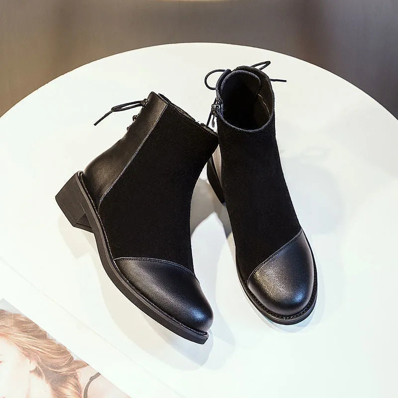 Black knee-high women's Martin boots with a side zipper, round toe, and bow detail.