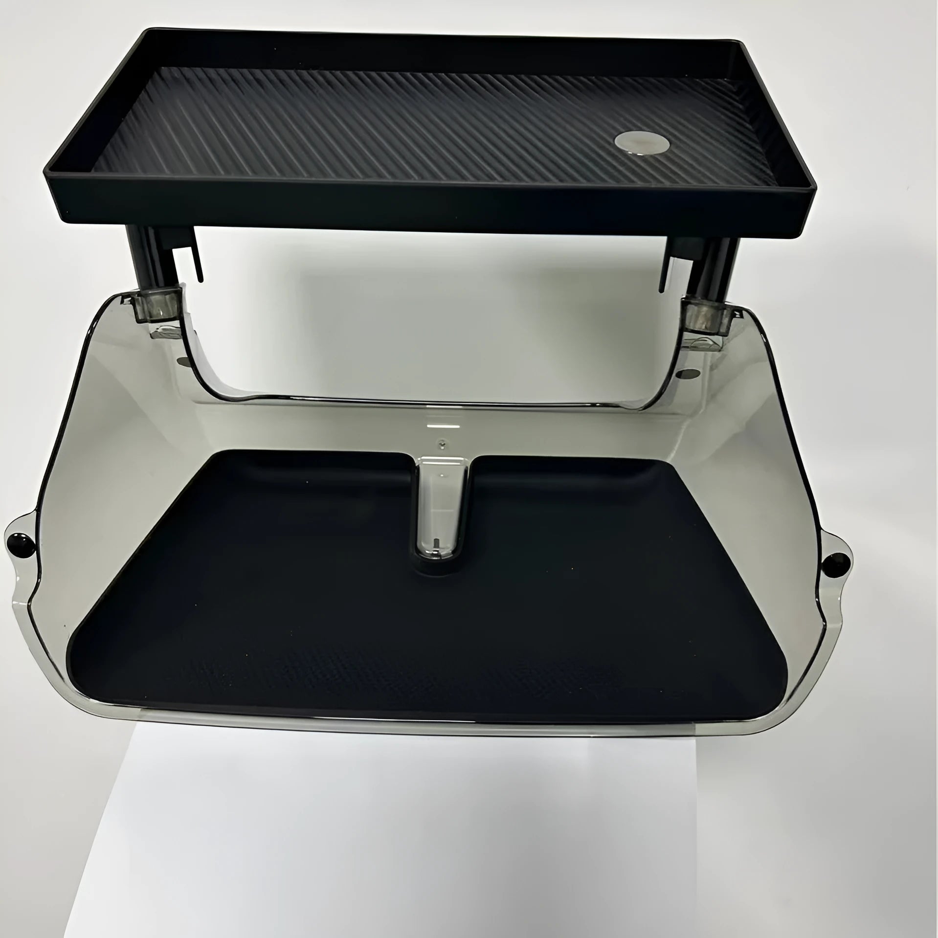 Black ABS plastic storage box installed under the screen of a Tesla Model Y centre console.
