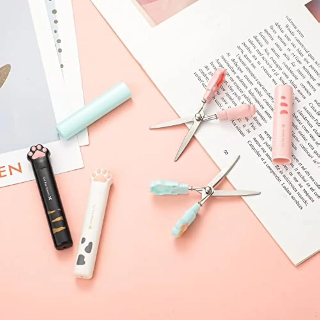 Closed cat paw design folding scissors showing stainless steel blades and handles in one of four colours.