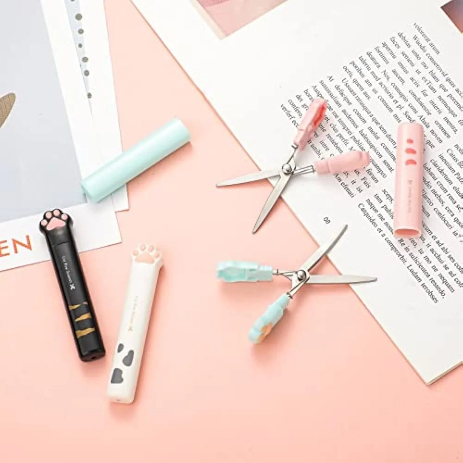 Closed cat paw design folding scissors showing stainless steel blades and handles in one of four colours.