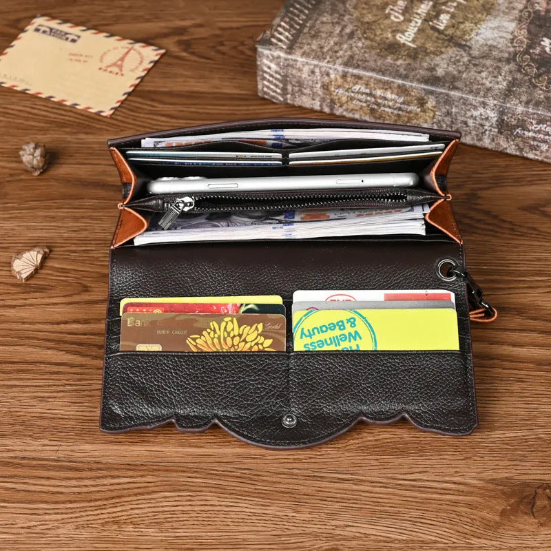 Women's brown embossed floral pattern tri-fold leather wallet showing open compartments