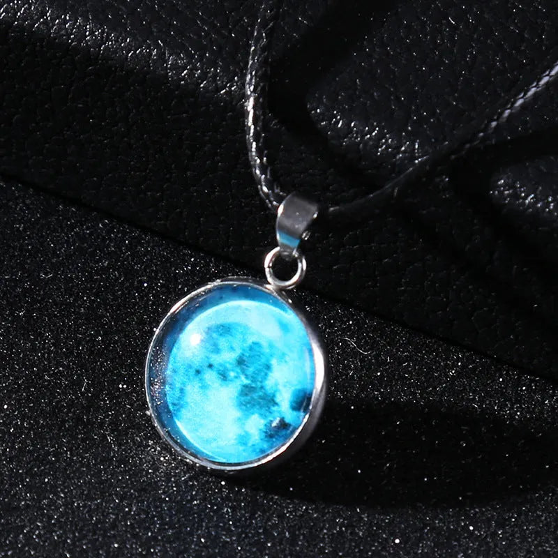 Luminous Christmas moon and night sky pendant necklace with adjustable chain on display