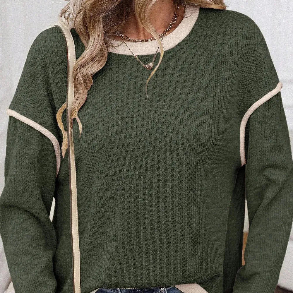 Beige loose knit top with green four leaf clover contrast trim and drop shoulders.