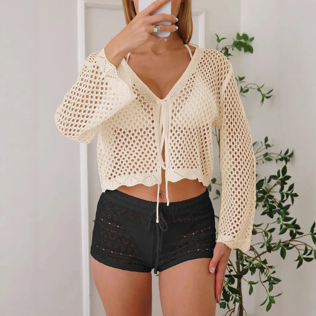 Light khaki women's cardigan blouse with bell sleeves and a cropped hem on a hanger.