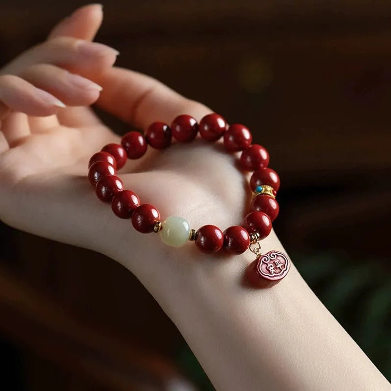Natural cinnabar Emperor Sandstone Ping An Fu Lu bracelet with red beads.