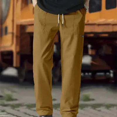 Men's polyester trousers for spring and autumn in light grey, shown in a casual setting.