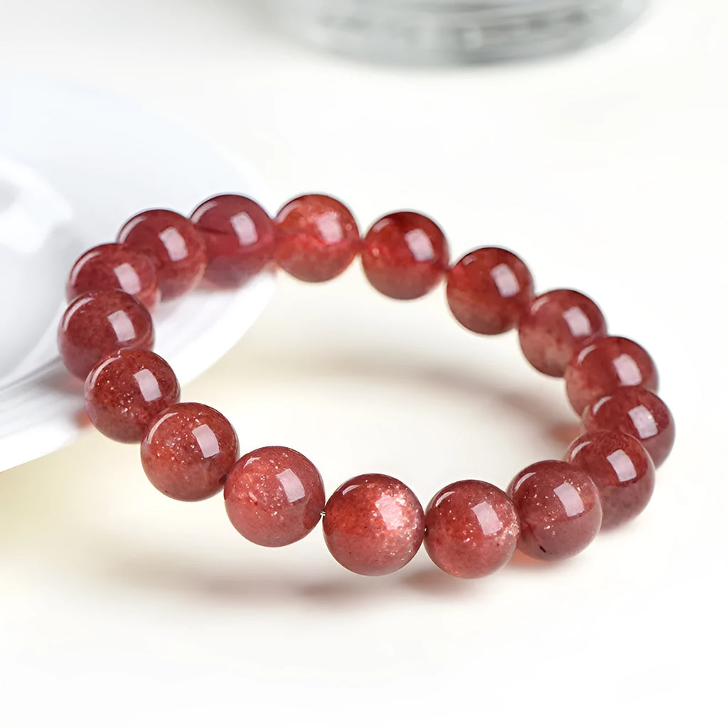 Natural cherry red strawberry quartz bracelet with geometric cut stones on wrist