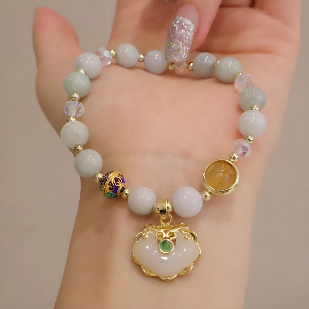 Geometric grey jade and metal ethnic bracelet for women on a wrist.