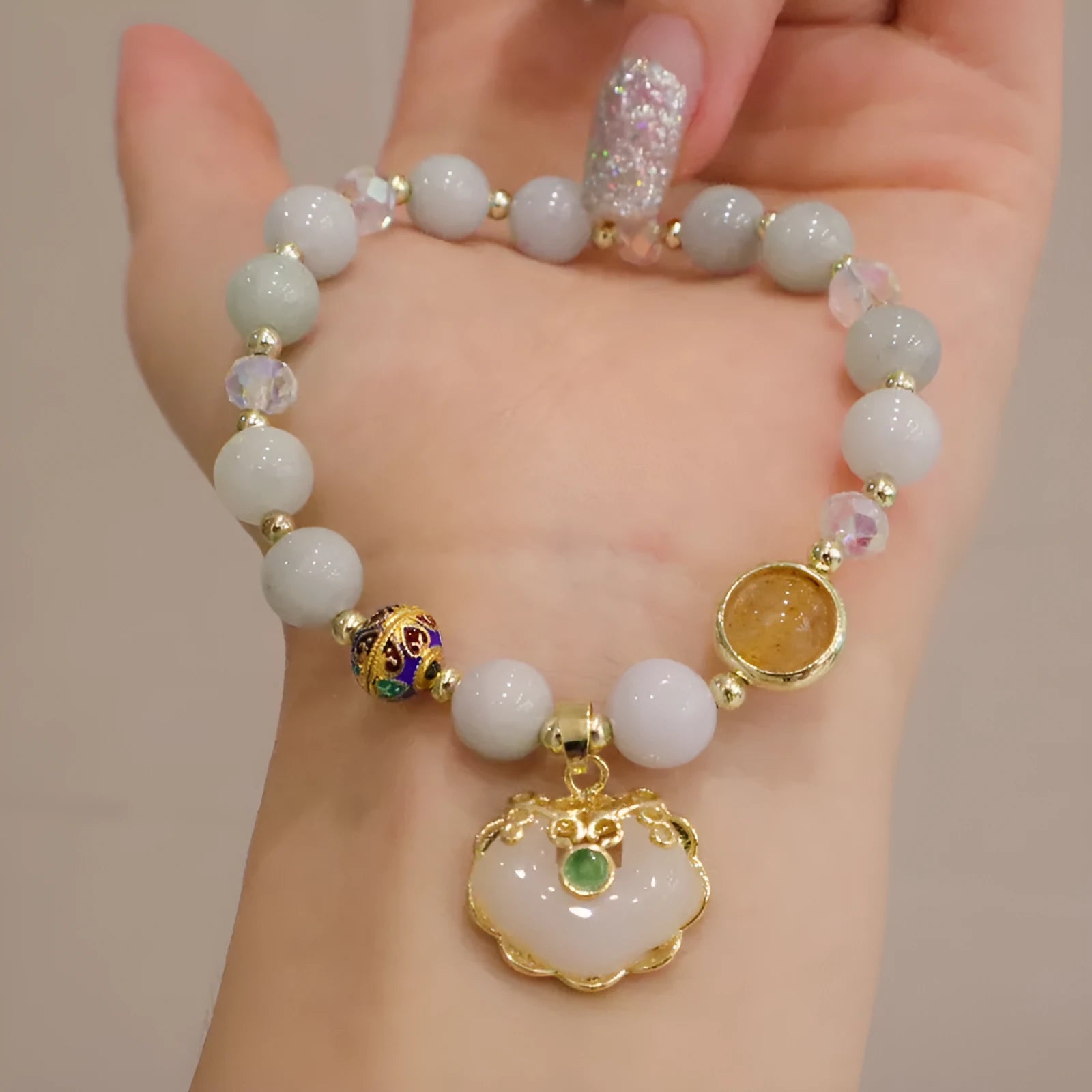 Geometric grey jade and metal ethnic bracelet for women on a wrist.