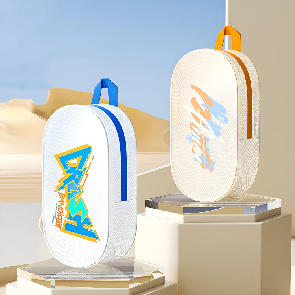 Orange and Violet coloured EVA waterproof storage bags in small and large sizes on a beach towel.