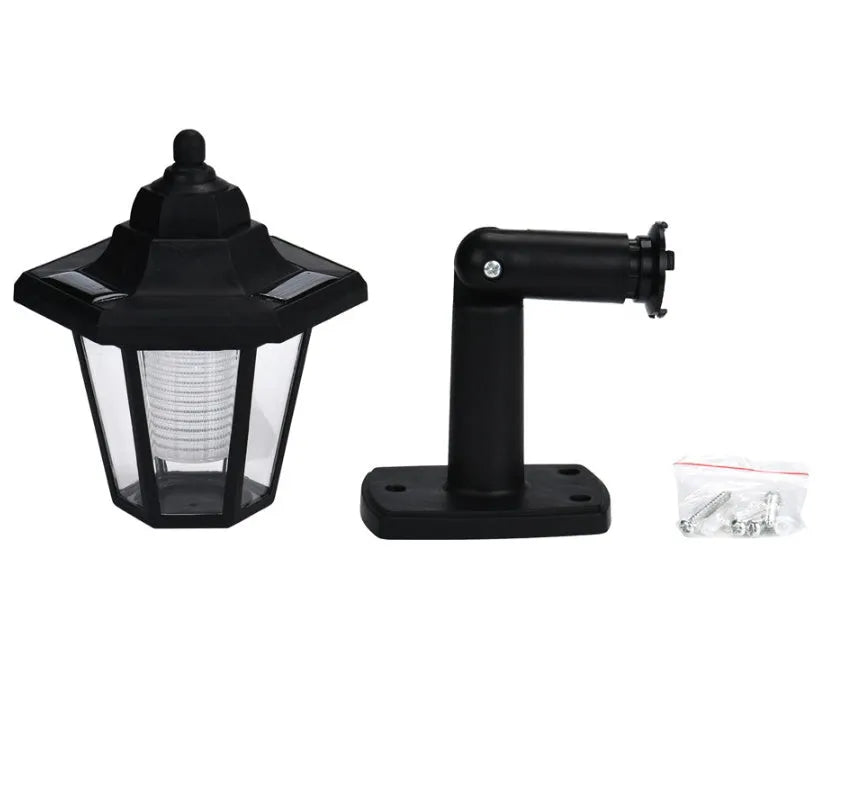 Black hexagonal solar wall lamp with integrated solar panel for outdoor garden or patio lighting