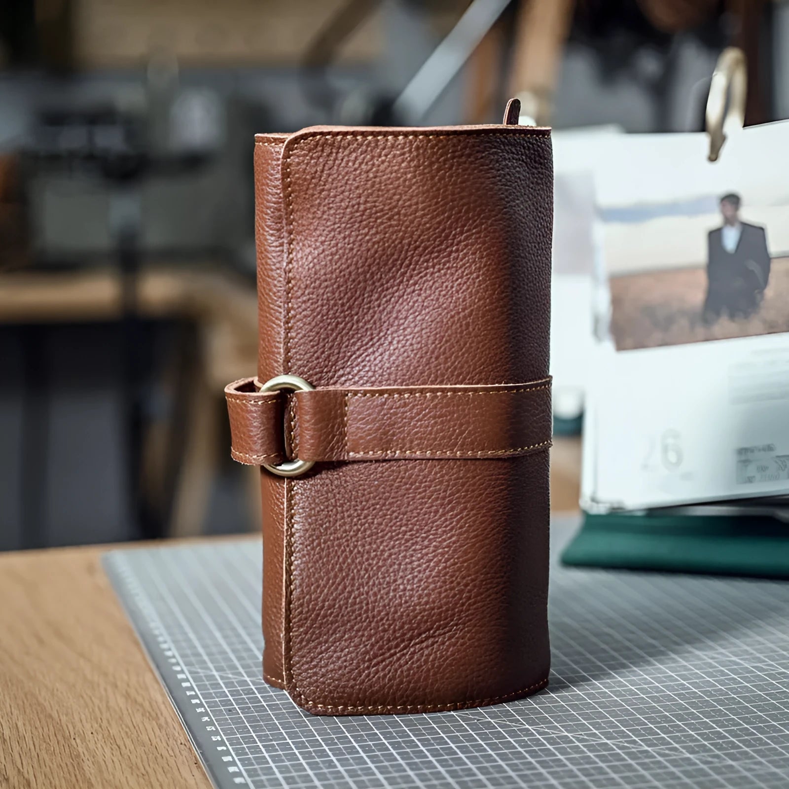 Handmade solid colour cow leather vintage wallet with tape closure, shown in black and dark brown.