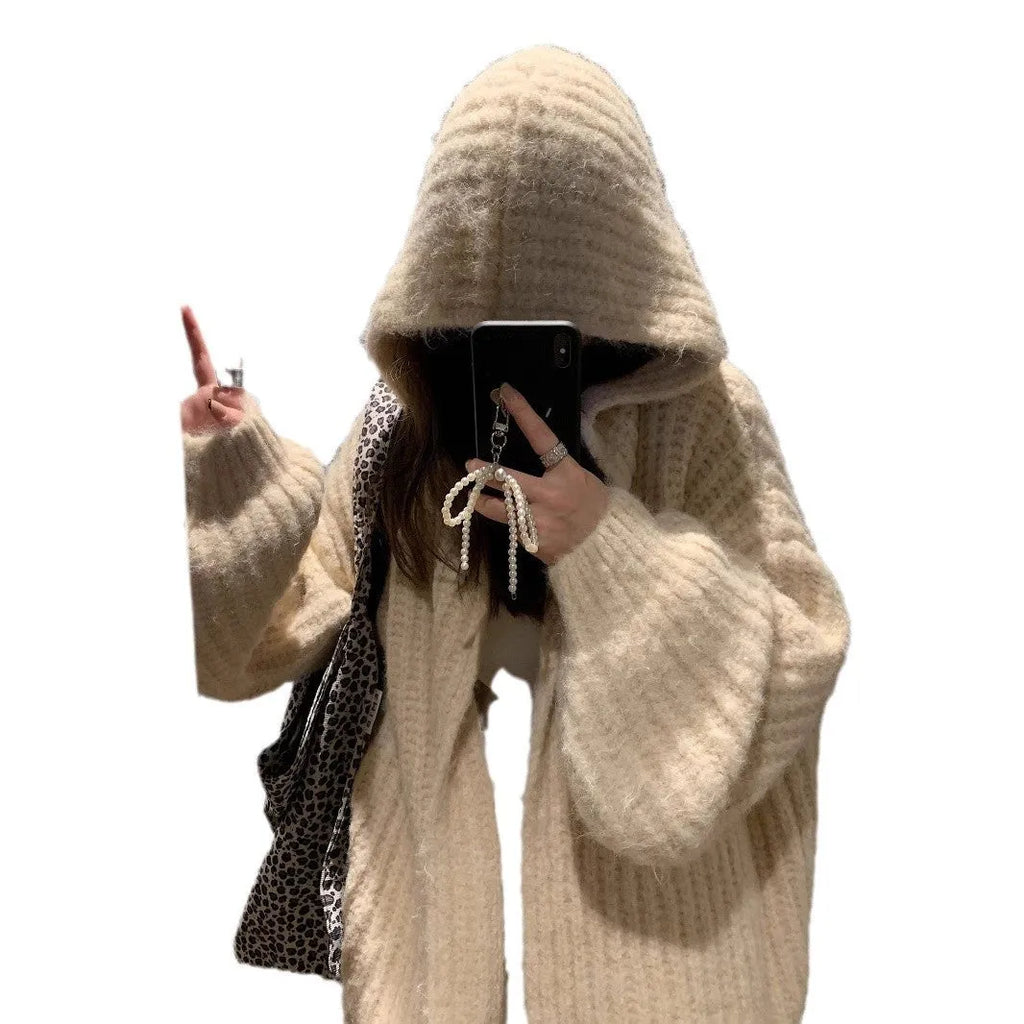 Woman wearing a dark gray retro-style hooded cardigan sweater with a loose fit.