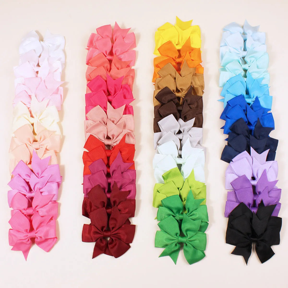 Assortment of colourful 3-inch grosgrain ribbon pinwheel hair bows with alligator clips for toddlers.