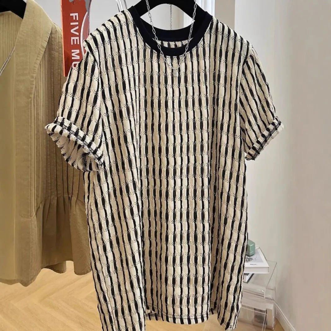 Black men's loose-fitting striped short sleeve pullover top made from silk and linen blend.