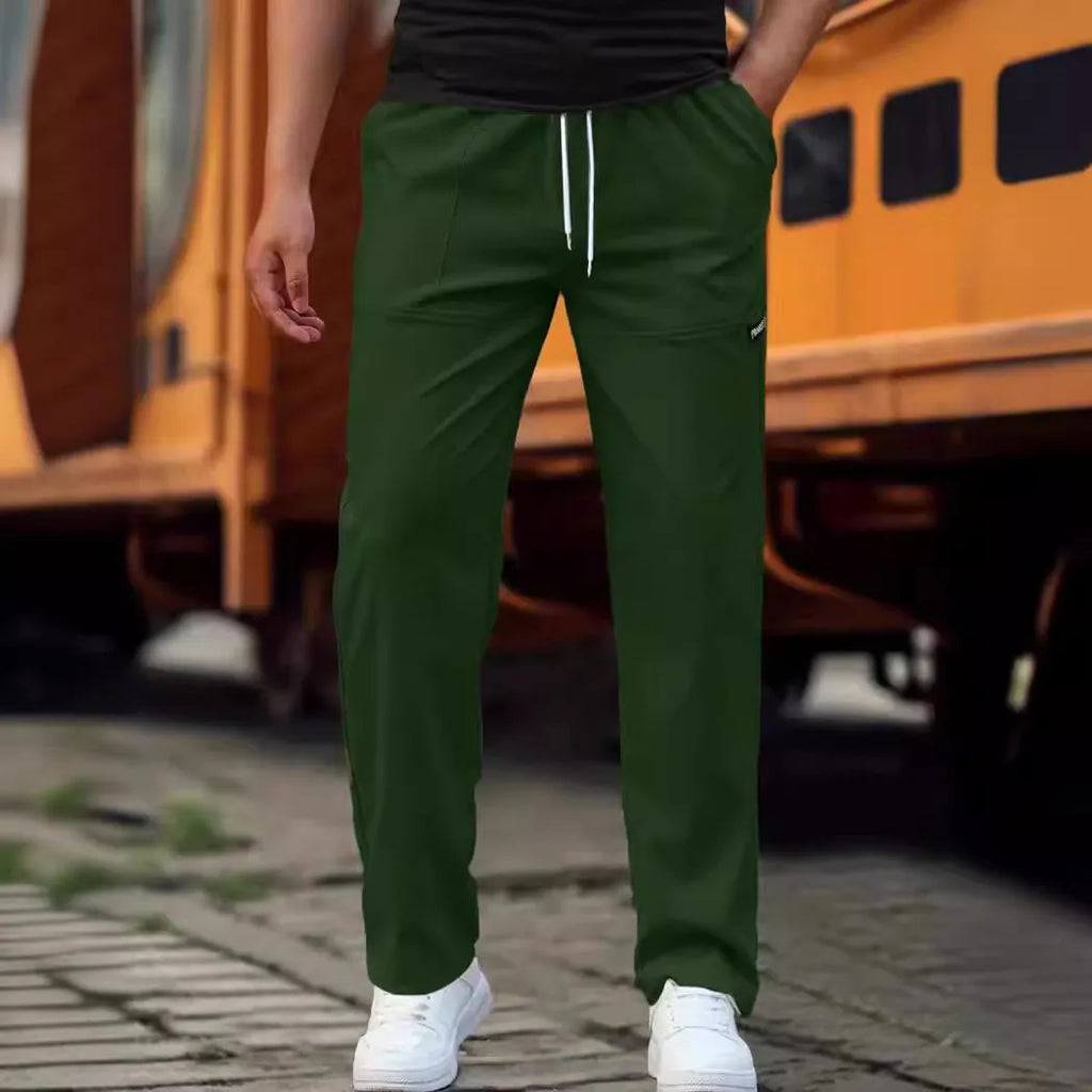 Men's polyester trousers for spring and autumn in light grey, shown in a casual setting.