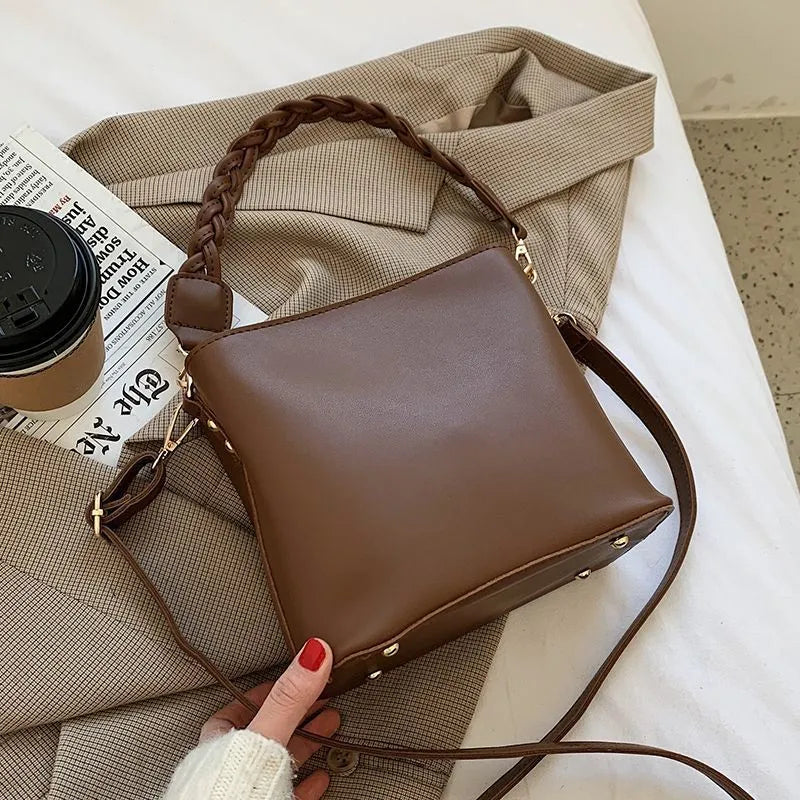 Retro woven PU leather crossbody bucket bag in khaki colour showing adjustable strap and bucket shape