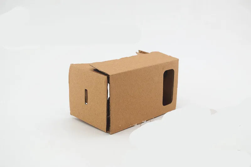 Pink and white cardboard VR glasses with rubber head strap and magnetic button for smartphones.