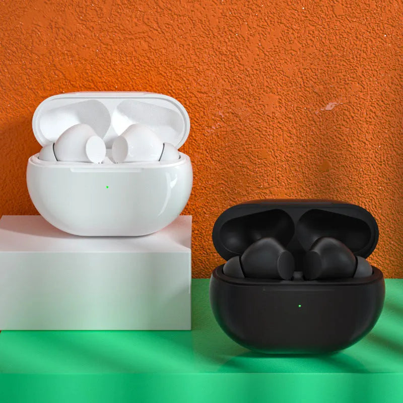Black and white Pro4 Bluetooth headset with charging case on a table.
