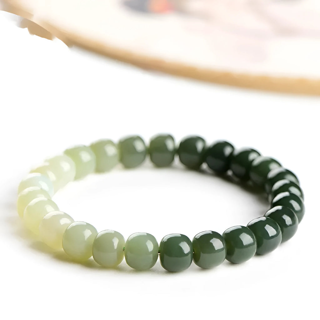 Natural Hetian jade bracelet with water gradient colour on a wrist.