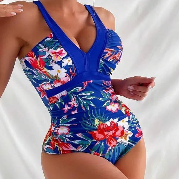 Women's black floral backless one-piece swimsuit on a model, showing spandex lining and high elasticity fit.
