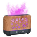 Christmas snowflake pattern ultrasonic aromatherapy humidifier with colourful flame light effect on a desk.