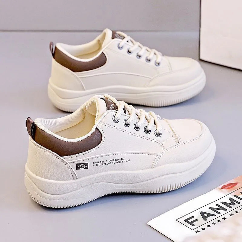 Women's white Korean-style low-top pumps with cross straps and lace-up front on a rubber sole.