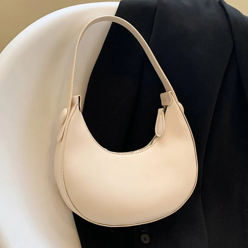 Women's retro dumpling-shaped shoulder bag in PU leather, shown in black, featuring an outer sandwich pocket.