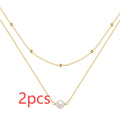 S925 sterling silver double layer necklace with twin diamond-treated pearls and geometric design.