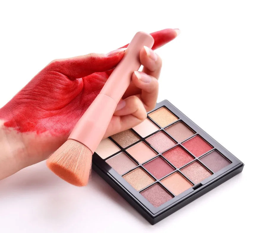 Ten professional makeup brushes with wooden handles in a pink box, including powder, foundation, and double-ended brushes.