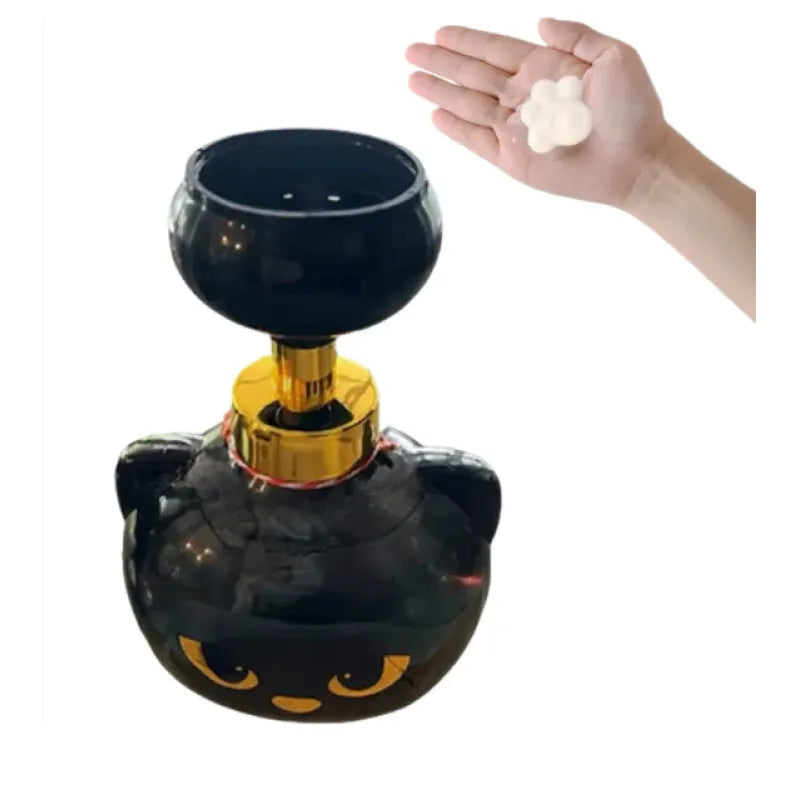 Black plastic cartoon cat-shaped foam soap dispenser on a counter.