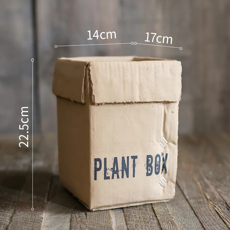 Cement flowerpot with perforated base and imitation carton paper texture for indoor planting
