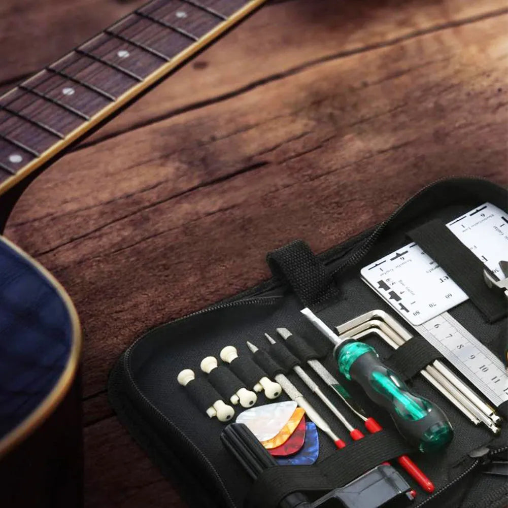 Black plastic case of guitar repair tool kit with metal components for instrument maintenance.
