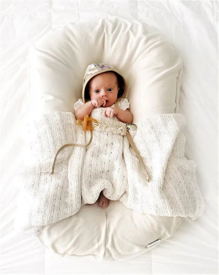 Beige portable baby nest bed crib measuring 75cm by 45cm for newborns