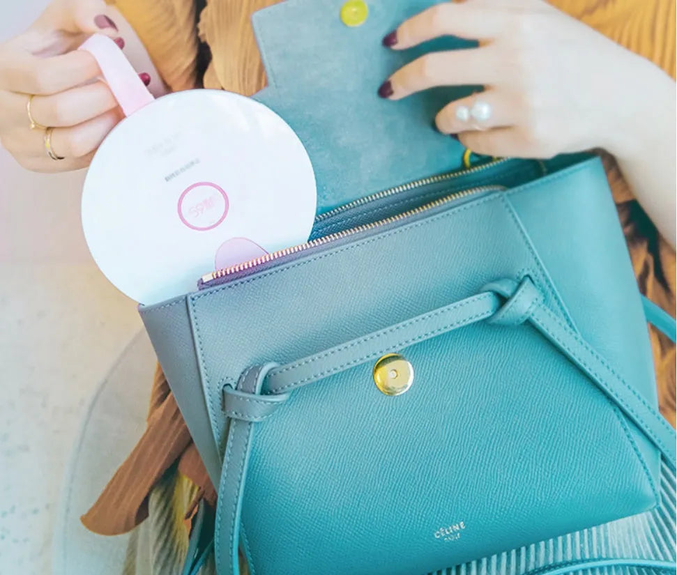 A slim, portable baby bottle sterilizer in blue or pink, showing USB port and compact design.